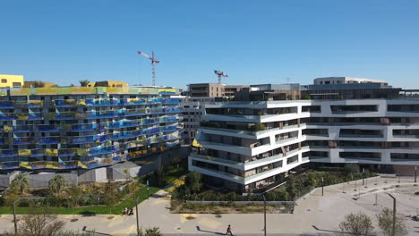 Sideway-drone-shot-of-modern-eco-buildings-in-Montpellier-Port-Marianne.-Aerial